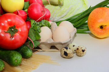 online shopping, home delivery food eggs, pasta, fruits, vegetables, tomatoes, cucumbers, cabbage, radishes, apples in a paper bag
