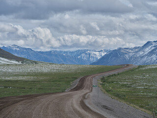 Dirt and gravel Dalton Highway looking south to the Brooks Range north of the village of Nuiqsut Alaska