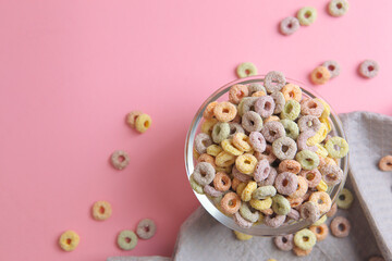 Multicolored corn rings for breakfast on a colored background