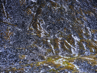 Graphic resource image of fresh snow along the rugged mountain cliffs with fallen rocks along the Dalton Highway Alaska