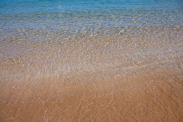 Blue ocean wave on sandy beach. Beach in sunset summer time. Beach landscape. Tropical seascape, calmness, tranquil relaxing sunlight.