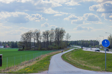 Beautiful countryside landscape view.  Road sign for pedestrians and bicycles on front.  Sweden. Europe. 