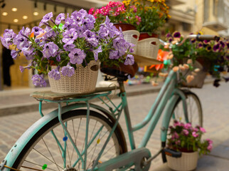 Fototapeta na wymiar An old bicycle equipped with potted flowers adorns the street of a Greek resort town, Greece, Crete, Rethymno