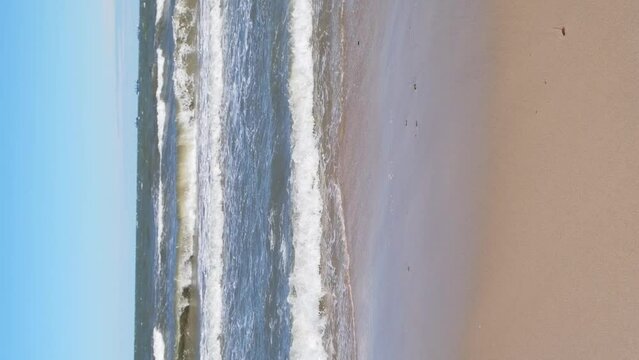 Baltic sea Dark blue clouds and sea or ocean water surface with foam waves before storm, dramatic seascape background. Incredible sunsets. Abstract natural pattern texture. Vertical footage 