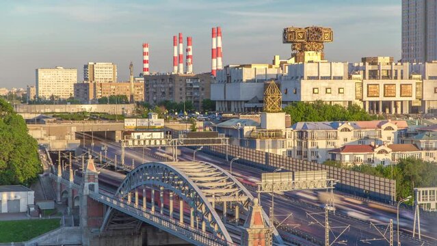 Evening view to the Russian Academy of Sciences timelapse at sunset and Novoandreevsky Bridge over the Moscow River. Aerial view from rooftop. Traffic on the road