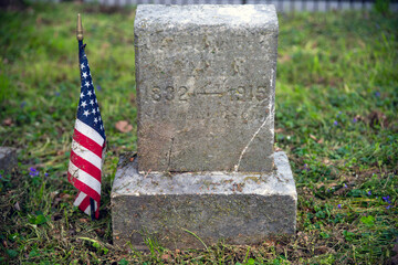 Civil War soldier cemetery gravestone with American Flag