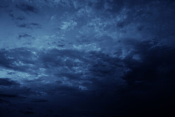 Black blue evening night sky with clouds. Dark dramatic sky background. Before the storm,...