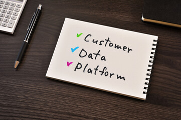 There is notebook with the word Customer Data Platform. It is as an eye-catching image.
