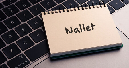There is notebook with the word Wallet. It is as an eye-catching image.