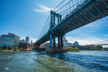 Manhattan Bridge view from East River at sunrise
