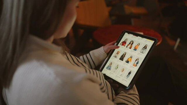 Shopping with Ease: Woman Uses Tablet to Purchase Clothes
