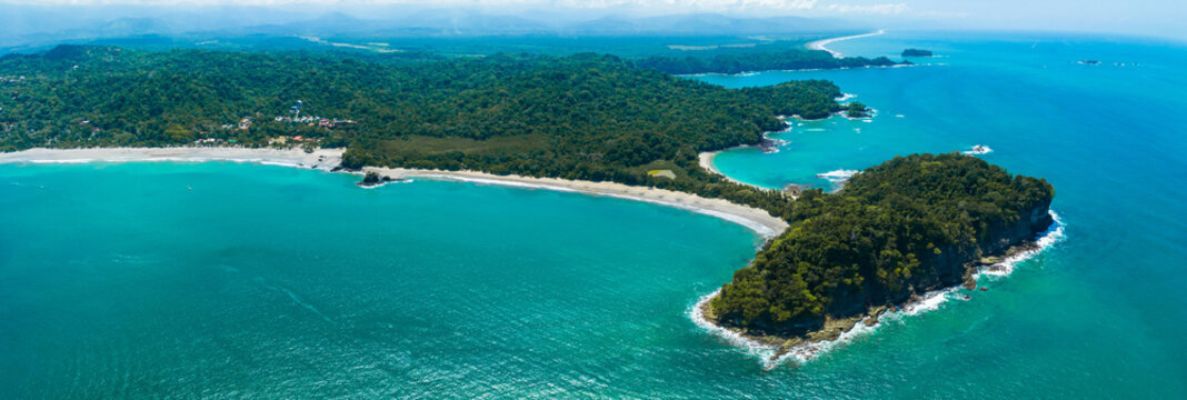 Aerial view of Manuel Antonio National Park in Costa Rica. The best Tourist Attraction and Nature Reserve with lots of Wildlife, Tropical Plants and paradisiacal Beaches on the Pacific Coast.