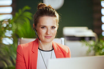 Portrait of modern business woman at work in red jacket