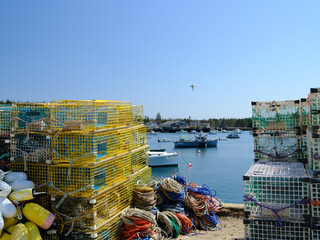 Hundreds of empty lobster traps or lobster pots sit on a dock waiting for loading onto outbound lobster boats on Vinalhaven Island Maine