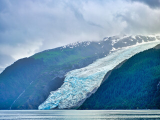 Blue ice Glacier coming down from the mountains into Prince William Sound near Whitter Alaska
