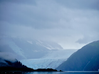 Blue ice Glacier coming down from the mountains into Prince William Sound near Whitter Alaska