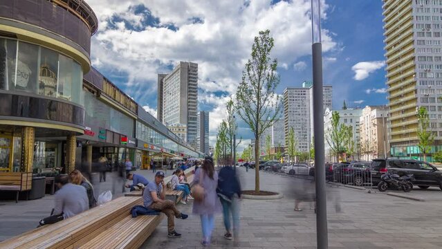 Walk on New Arbat Avenue timelapse hyperlapse popular tourist street in Moscow with shops and cafe in sunny summer day. Famous landmarks houses as books. People sitting on a benches