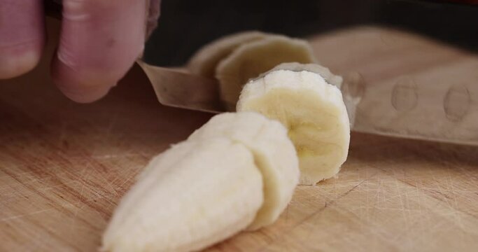 cut a fresh ripe banana, fresh pieces of banana that are used in the preparation of banana yogurt