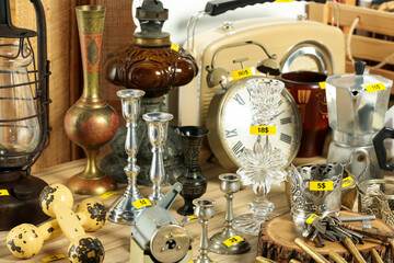 Many different items on wooden table. Garage sale