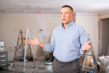 Portrait of confused man owner of apartment looking at repair works results.
