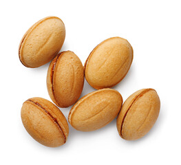 Delicious nut shaped cookie with boiled condensed milk on white background, top view