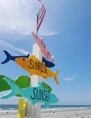 Foto op Plexiglas Sunrise and Sunset fish direction arrow sign on the Sunset Beach NC pier © zimmytws