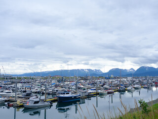 Fototapeta na wymiar Reflections on the calm and protected harbor on the Homer Spit in Alaska on Kachemak Bay