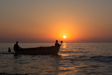 Fisherman in boat get fishing nets from river, Silhouette of fisherman,a dip net for fishing at Pakpra village, jijel Algeria Africa, Silhouette Lifestyle of African Fisherman Fishing Nets on boat