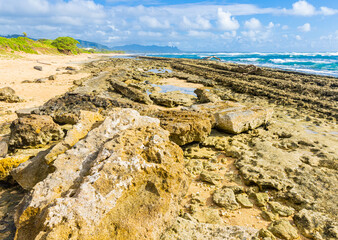 Exposed Coral Reef With  Sleeping Giant Mountain in The Distance, Nukolii Beach, Kauai, Hawaii, USA