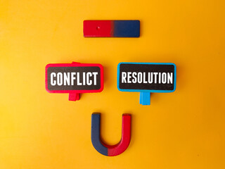 Magnet and wooden board with the word CONFLICT RESOLUTION