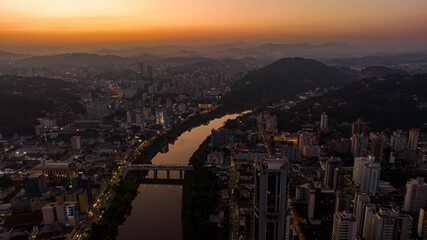 Fototapeta premium Aerial drone footage of the late afternoon with a beautiful sunset in Blumenau in Santa Catarina