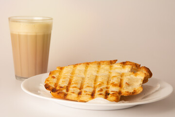Toasted bread with melted butter, Brazilian breakfast food, Coffee and Milk