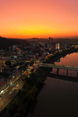 Fototapeta premium Aerial drone footage of the late afternoon with a beautiful sunset in Blumenau in Santa Catarina