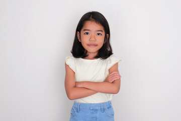 Asian little girl looking confident with arms crossed