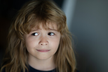Child imagining idea concept. Portrait of funny blonde kid. Close-up face of cute child. Portrait of kid boy at home. Close up face of happy child alone.
