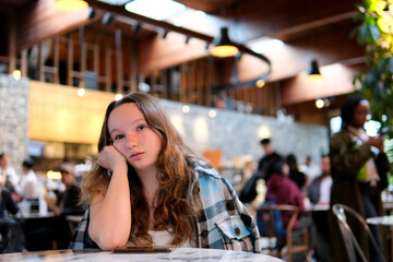  Bored Woman Waiting a Phone Call in Restaurant. Lonely woman feeling depressed and disappointed after a cellphone breakup 