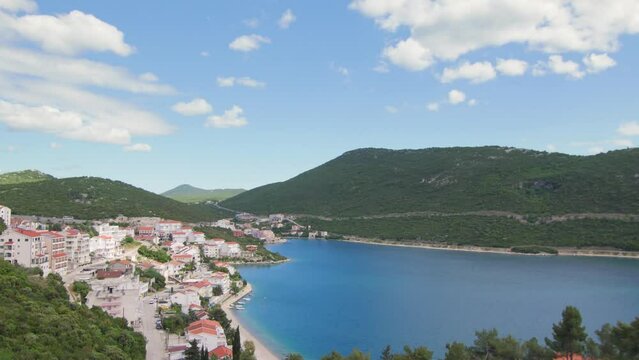 Timelaps of clouds passing over the bay of Neum with its beach by the sea, in Bosnia
