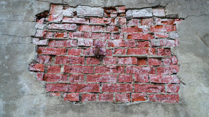Cracked cement wall with red brick texture. Background