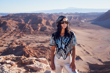 Naklejka premium portrait mid adult woman at the Moon Valley viewpoint in San Pero de Atacama