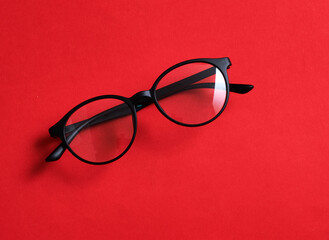 Black frame glasses isolated on red background for the poster design