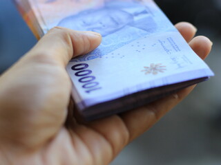 money ten thousand in hand