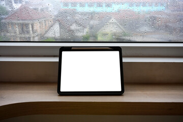 Mockup blank screen tablet and gadget on wooden table. over wooden balcony as background.