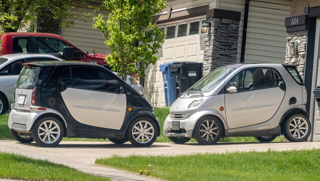 Calgary, Alberta, Canada. May 22, 2023. A couple of Smart fortwos. A rear-engine, rear-wheel-drive, 2-passenger city car manufactured by the Smart division of the German multinational Mercedes-Benz