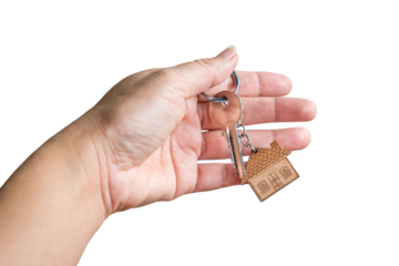 Hand holding the key with a house keychain. Isolated, transparent background.