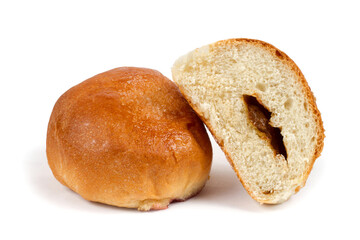 Sweet bread with filling. A whole and half a bun. Round bun on a white background.