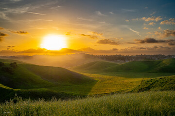 Fototapeta premium Sunset Over the Hills and meadows