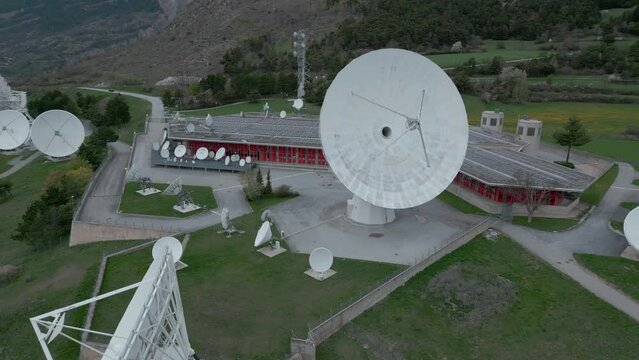Aerial shot of giant satellite in Leuk, Switzerland. Large and small parabolic antennas transmit and receive signals