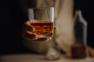 Bartender serving whiskey on wooden bar ,Close-up shot of whiskey glass