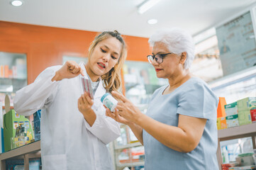 Pharmacist giving advice And advice for patients who come to buy Medicine, Drugs, Vitamins products, according to prescriptions in modern pharmacies.