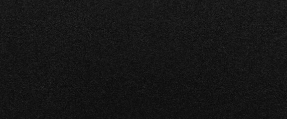 Texture of a wood splinter pressed wall, black painted surface of dark pressed wood chipboard texture background, the texture of the wood particle board painted black color.
